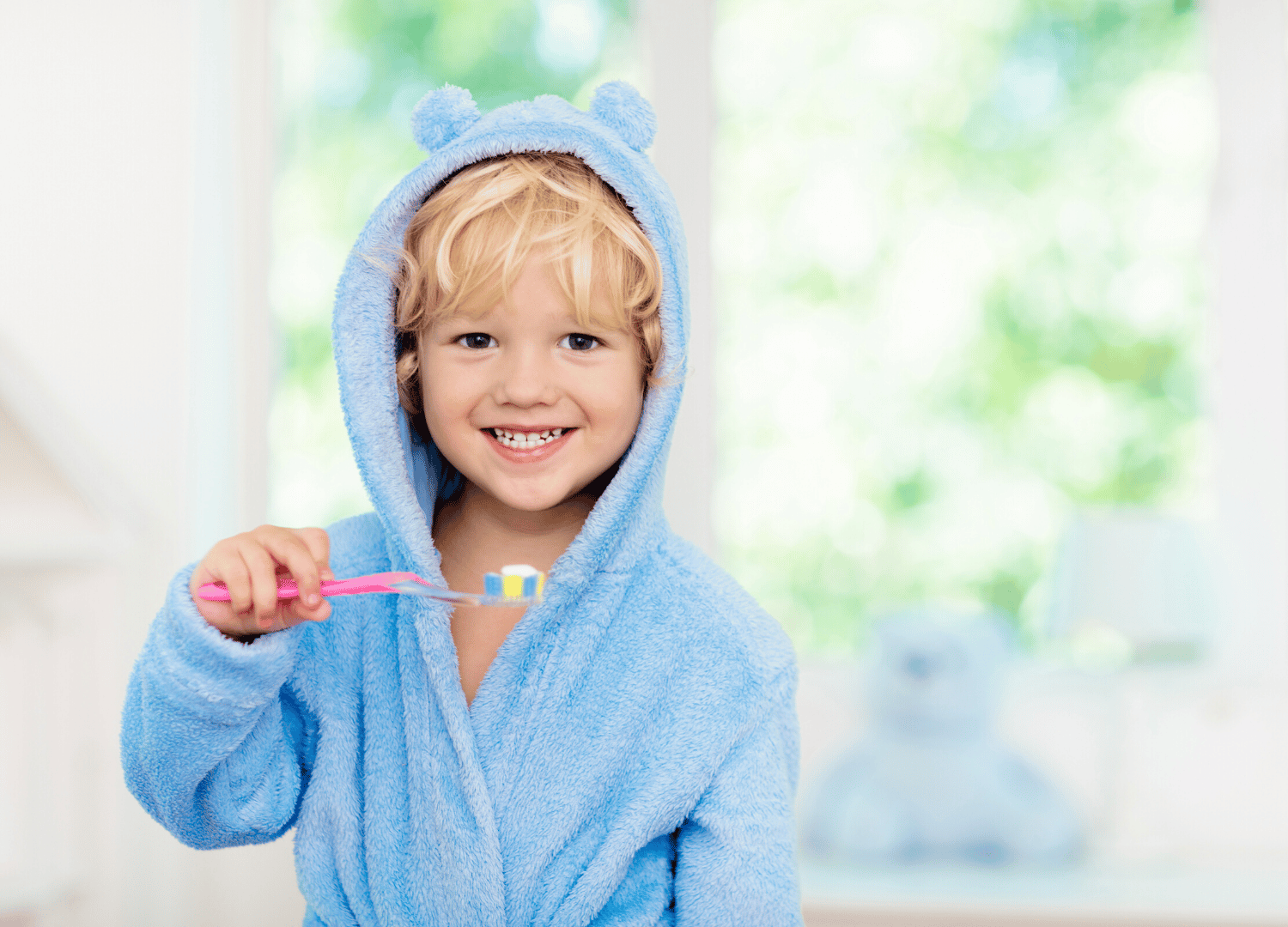Smiling child holding toothbrush