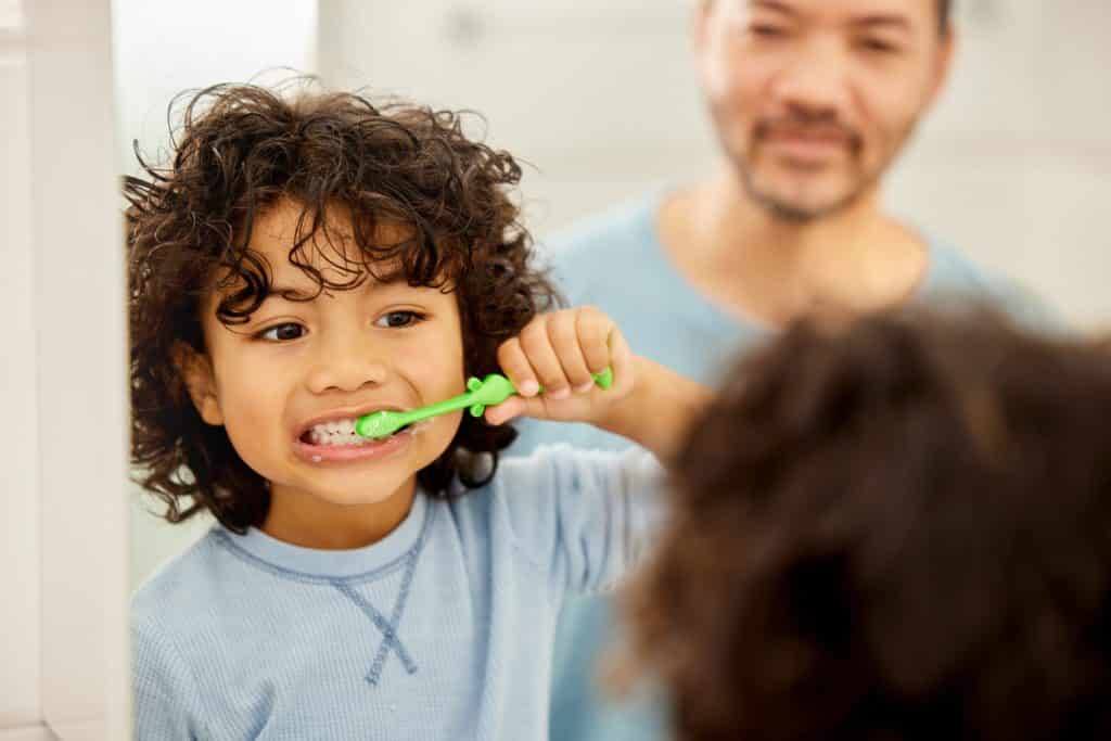 kid brushing teeth pediatric dentist calgary