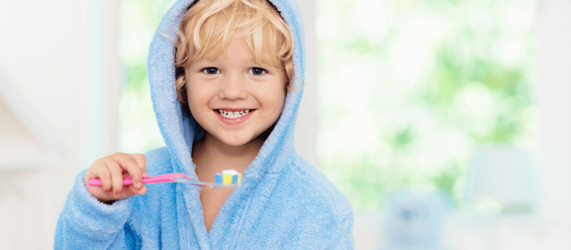 Smiling child holding toothbrush